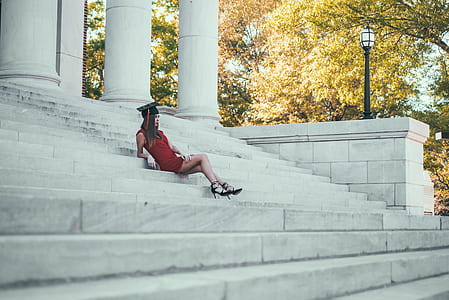 woman wearing black mortar board sitting on stairs thumbnail