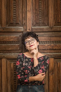 woman leaning on brown wooden wall thumbnail