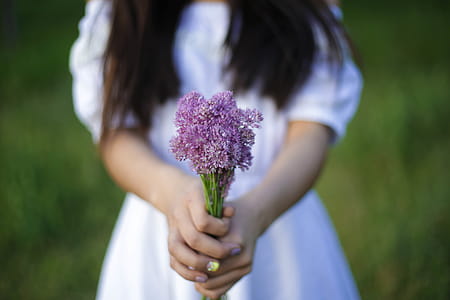 Photo of Person Holding Purple Flowers thumbnail