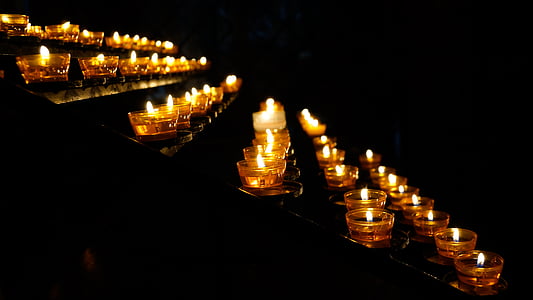 low light photography of votive candles lighted up thumbnail