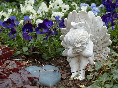 white ceramic angel statuette near purple and white flowers thumbnail