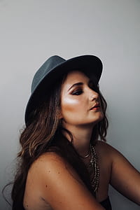 woman with chin up beside wall thumbnail