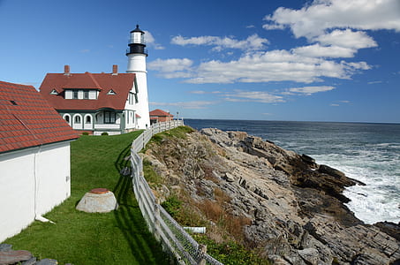 photography of lighthouse near sea during daytime thumbnail