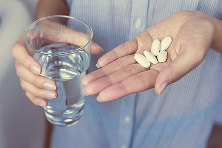 Hands of girl holding pills thumbnail