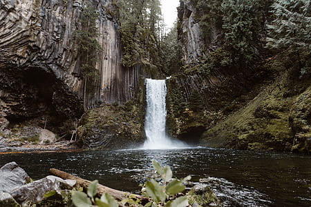 waterfalls between gray fault block mountains during daytime thumbnail