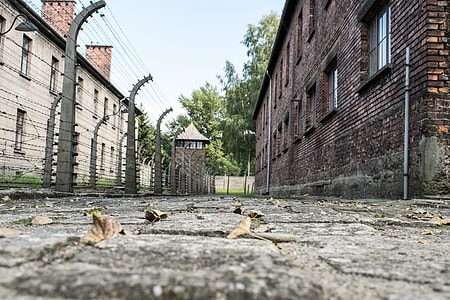 gray metal fence in between brick buildings at daytime thumbnail