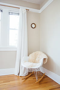 gray metal base white padded rocking chair on brown parquet flooring thumbnail