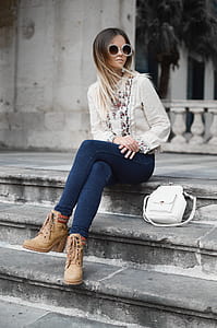 woman sitting on gray concrete stair at daytime thumbnail