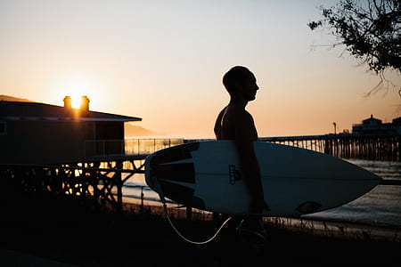 man carrying surfboard thumbnail