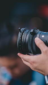 person holding black DSLR camera thumbnail