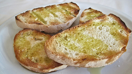 garlic breads on white ceramic plate thumbnail