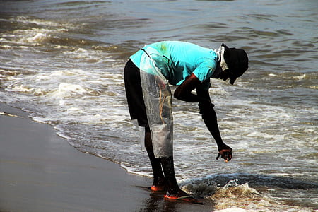 man standing near ocean water thumbnail