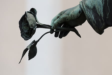 human hand holding rose statue thumbnail