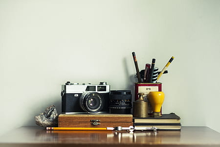 SLR camera on wooden case and pencil thumbnail