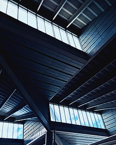 low-angle photography of building interior with clear glass windows and gray ceiling thumbnail