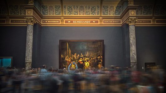 time lapse photo of people looking at painting on the wall thumbnail