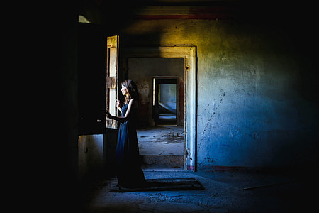 woman with black dress on window during daytime thumbnail