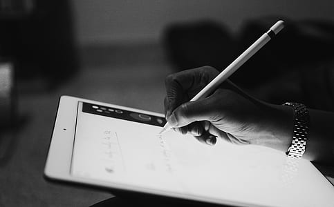 grayscale photo of person drawing on tablet computer thumbnail