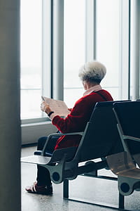 Person In Red Coat Sitting On Chair thumbnail