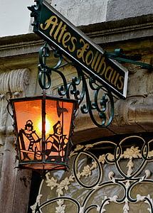green and yellow steel Altes Lollhaus signage with hanging lamp thumbnail