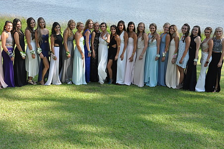 group of women wearing prom dress gathered for a photo during daytime photography thumbnail