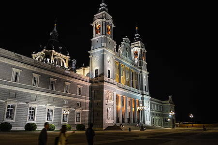 people near white building at night thumbnail