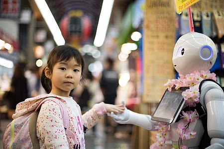 girl holding hand of automated robot thumbnail