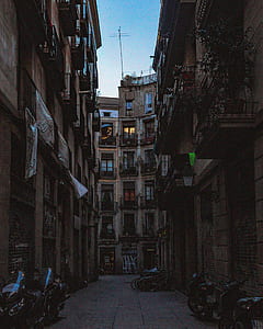 motorcycle and bicycles parked outside high-rise buildings thumbnail