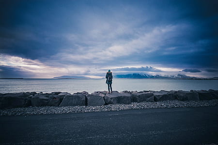 person standing near body of water thumbnail