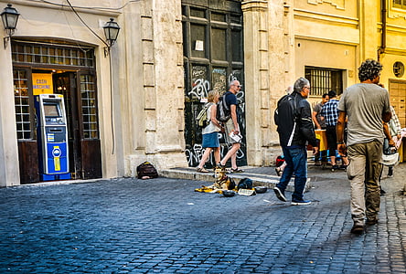 man and woman walks beside gray painted building thumbnail