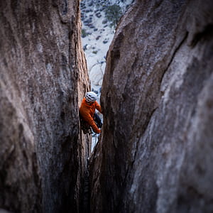person climbing on cliff at daytime thumbnail