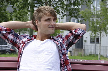 man sitting on a bench with both hands on head thumbnail