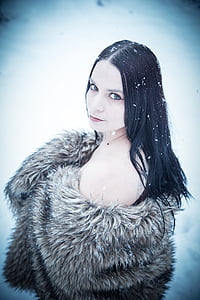 woman in brown coat standing on snow thumbnail