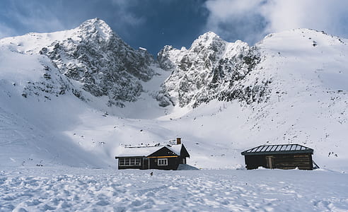 two houses in mountain covered in snow thumbnail