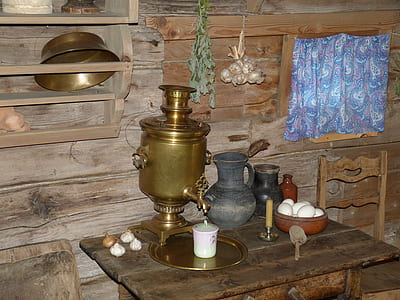 brass-colored teapot on desk near wall thumbnail