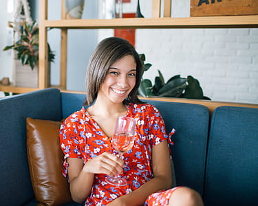 Woman Holding Wine Glass Sitting in Sofa thumbnail