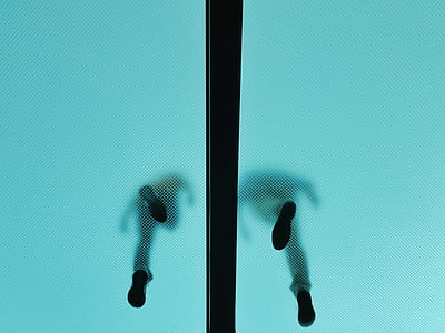 low angle photo of person walking on tinted floor thumbnail
