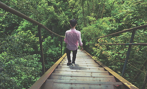 Man Wearing Pink Dress Shirt Walking Through Stairs thumbnail