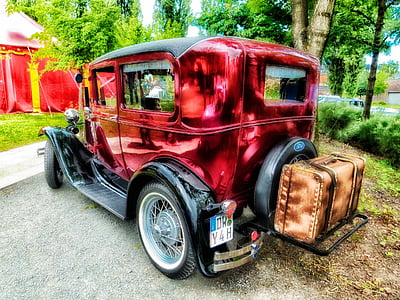 red SUV parked beside tree thumbnail