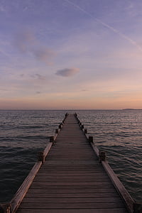 brown wooden dock on body of water during daytime thumbnail