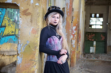 woman learning on wall taking photo shoot thumbnail