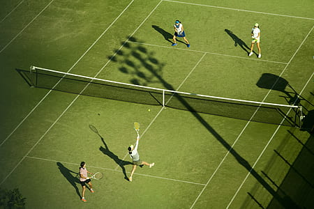 four women's playing tennis thumbnail