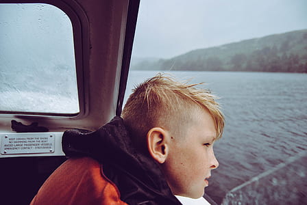 boy looking outside boats window thumbnail