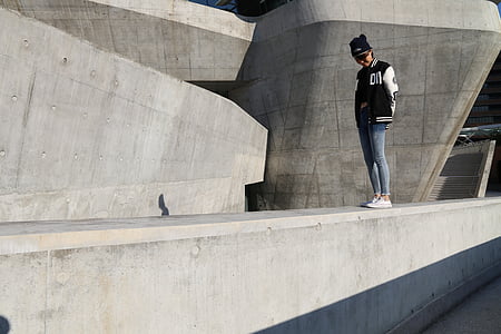 person standing on concrete wall thumbnail