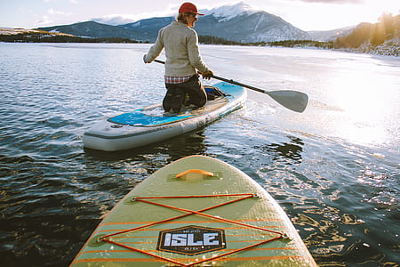 woman riding paddle boat on body of water thumbnail