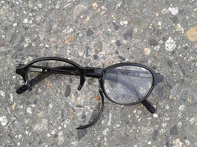 wrecked black frame eyeglasses on gray pavement thumbnail