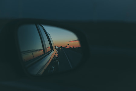 tilt shift lens photography of car side mirror during nighttime thumbnail