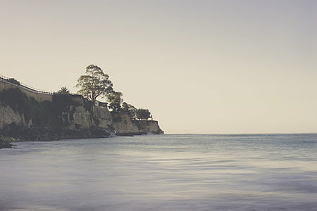landscape photography of bridge by the cliff of sea thumbnail