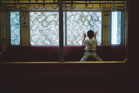 boy looking through train's window thumbnail