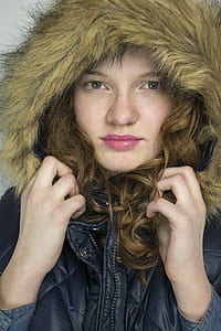 close-up photo of woman wearing black and brown parka jacket thumbnail
